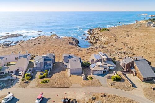 an aerial view of a house on a cliff next to the ocean at Del Mar Point in Sea Ranch