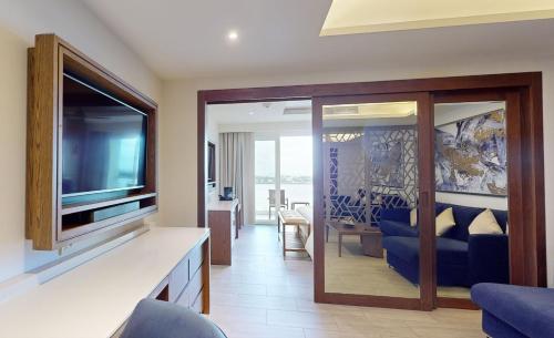 a living room with a flat screen tv and a living room at Royalton CHIC Cancun, An Autograph Collection All-Inclusive Resort - Adults Only in Cancún