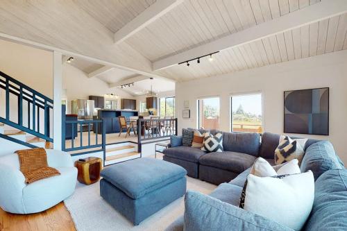 a living room with a blue couch and a table at The Great Escape in Sea Ranch