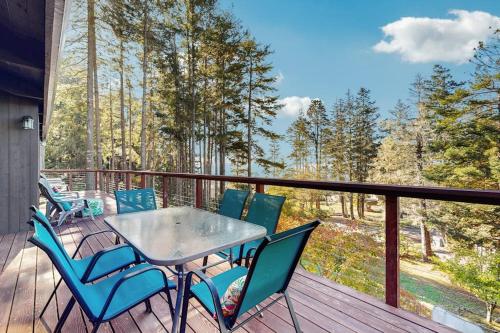 a table and chairs on a deck with a view at Sea Raven in Gualala