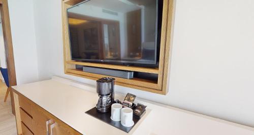 a counter with a coffee maker and a mirror at Royalton CHIC Cancun, An Autograph Collection All-Inclusive Resort - Adults Only in Cancún