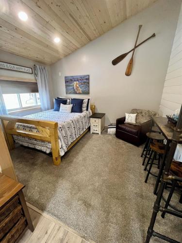 a bedroom with a bed and a table and a couch at Catch'em AK - Salmon Cove in Soldotna