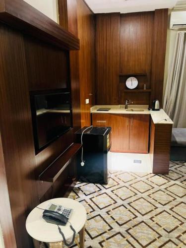 a bathroom with a sink and a table with a telephone at شقق هذا منزلي المخدومة in Riyadh