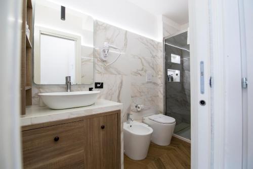 a bathroom with a sink and a toilet at Residenza sul mare 2 in Naples