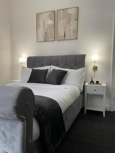 a bedroom with a large bed with two pillows at Modern Homes in Stoke on Trent
