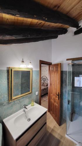 a bathroom with a sink and a glass shower at La Casona de Roser in Cardenete
