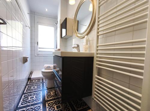 a bathroom with a toilet and a sink and a mirror at AC Apartaments Apollo Soldeu in Soldeu