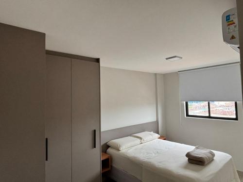 a bedroom with a bed and a cabinet and a window at Apto 2 Quartos Novo e Super Confortável in Arapiraca