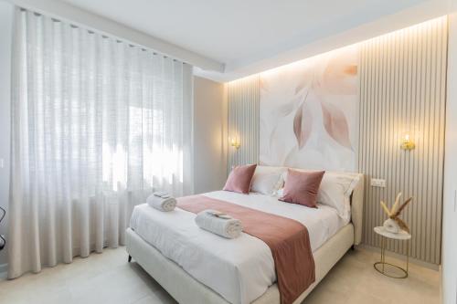 a bedroom with a bed with two towels on it at Campo's Guest House Airport in Bari