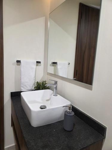 a bathroom with a white sink and a mirror at Apartment in downtown Zapopan in Guadalajara