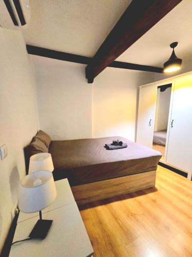 a bedroom with a bed and a table and a chair at Toledo Histórico in Toledo