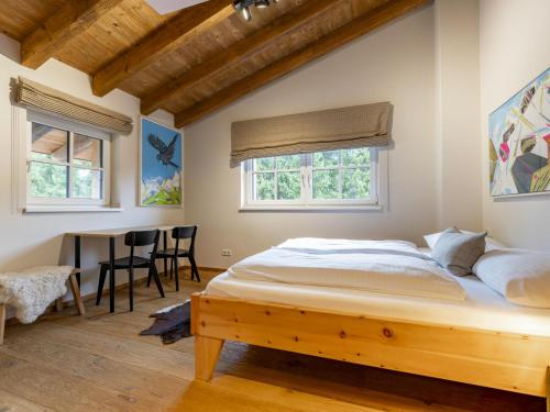 a bedroom with a bed and a table and chairs at Schneeflocke Leogang in Leogang