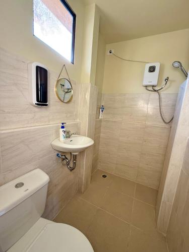 a bathroom with a toilet and a sink at Pads Guesthouse in San Vicente