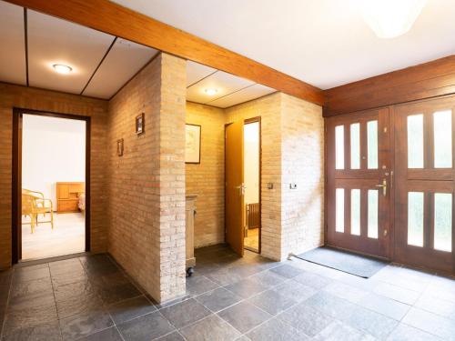 a hallway with a door and a room with a table at Steenenburg Zicht in Nieuwkuijk