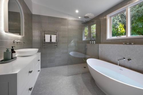 a bathroom with a tub and a sink and a bath tub at Little Wombat Daylesford in Daylesford