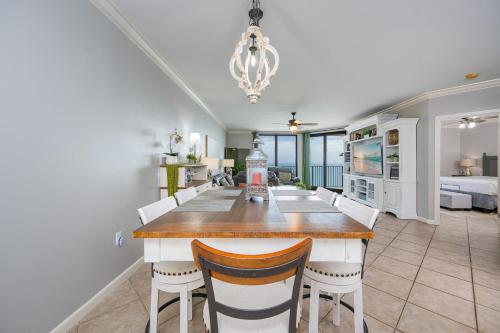 a kitchen and dining room with a table and chairs at Phoenix X 1504 condo in Orange Beach