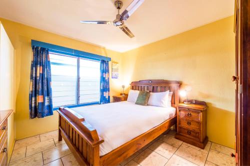 a bedroom with a large bed and a window at Clifton Beach House in Clifton Beach