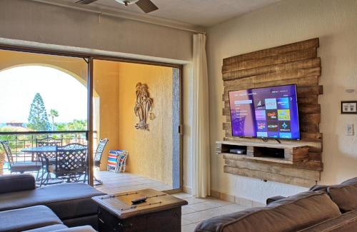 a living room with a couch and a flat screen tv at Princesa C206 -Arcade Game-Experience Rocky Point- in Puerto Peñasco