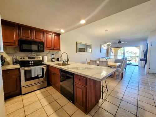 a kitchen with a sink and a stove top oven at Princesa C206 -Arcade Game-Experience Rocky Point- in Puerto Peñasco