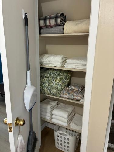 a closet filled with lots of folded towels at The Gateway Suite in Fortune