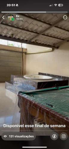 a picture of a room with a bed with avertisement at Casa 2 temporada in Trindade