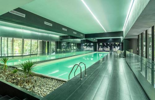 a large swimming pool in a building at Casa Magenta by Kukun in Mexico City