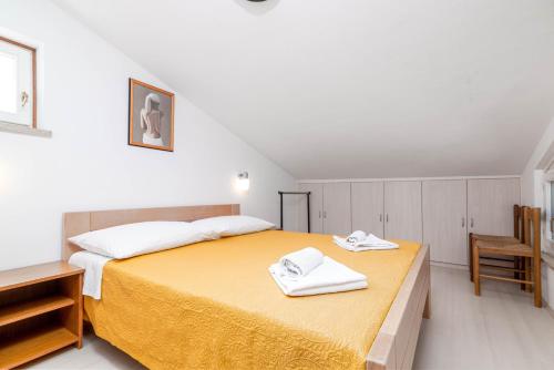 a bedroom with a bed with two towels on it at Apartments with parking space Rabac, Labin - 6464 in Rabac