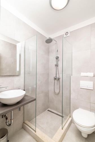 a bathroom with a shower and a toilet and a sink at Apartments with parking space Rabac, Labin - 6464 in Rabac