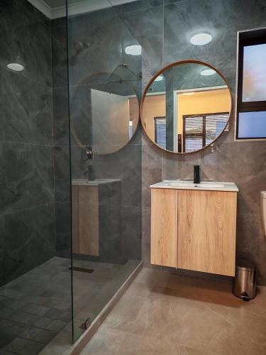 a bathroom with a sink and a mirror at King Superior Studio Room with En-Suit in Cape Town