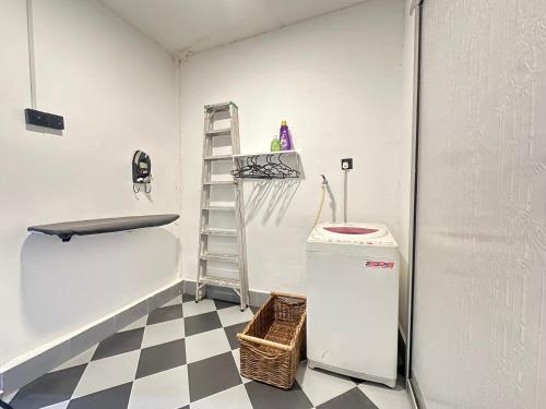 a room with a sink and a ladder and a refrigerator at Ellhavfiz Homestay in Tapah