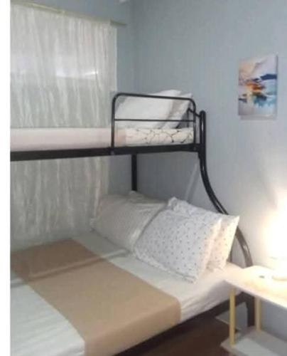 a bed with two bunk beds in a room at Bayanihan flats Condo in Pajak