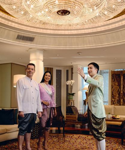 a group of three people standing in a hotel room at The Athenee Hotel, a Luxury Collection Hotel, Bangkok in Bangkok