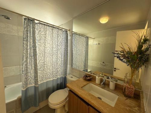 a bathroom with a sink and a toilet and a tub at Laguna del Mar, C 208 in La Serena