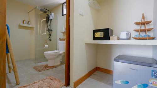 a bathroom with a toilet and a sink and a shelf at Azul Beach Resort in Bophut