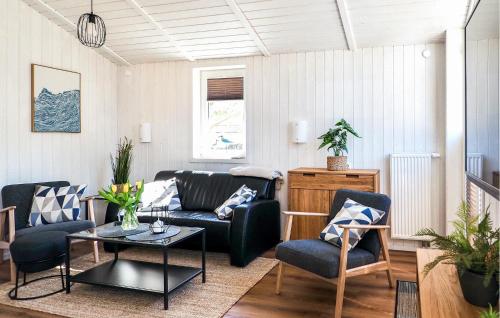 a living room with a couch and chairs and a table at Schatzkiste 3 - Dorf 4 in Travemünde