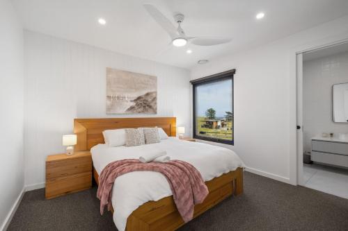 a bedroom with a large bed and a window at Island View San Remo in San Remo