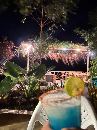 a drink sitting on a chair with a lime slice on it at Orika del Mar Hotel in Isla Grande