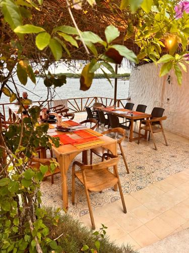 a group of tables and chairs in a patio at Orika del Mar Hotel in Isla Grande