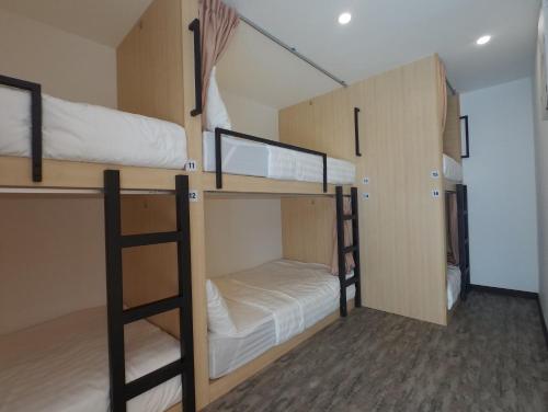 a room with two bunk beds in a room at Signel Hostel in Kota Kinabalu