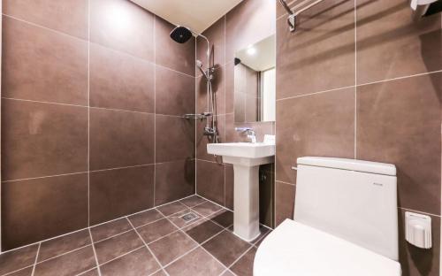 a bathroom with a toilet and a sink at Manwol Hotel in Ŭmnae