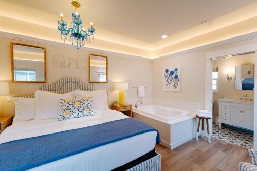 a bedroom with a bed and a tub and a sink at Lithia Springs Resort in Ashland