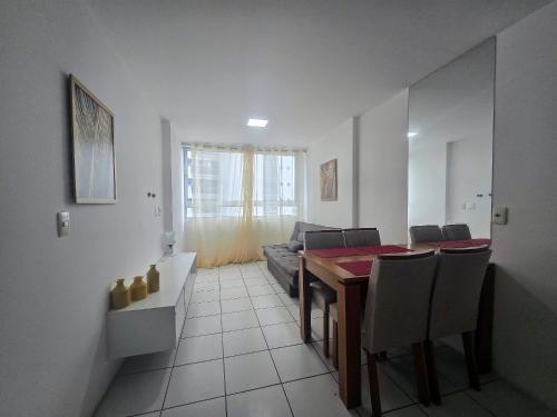 a living room with a table and a couch at Apto. 1 dorm. no Edf. Manhattan home service 605 in Caruaru