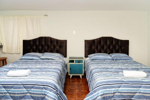 two beds sitting next to each other in a bedroom at Nice Apartment in Urubamba in Urubamba