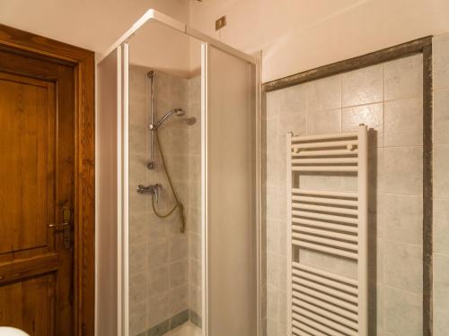 a bathroom with a shower with a glass door at Mansion with Pool and play area in Pian di Scò