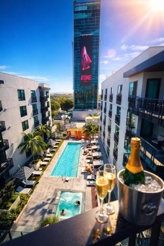 a hotel balcony with a swimming pool and glasses of wine at Hollywood Penthouse with Balcony Pool and Hollywood sign View with Free parking in Los Angeles