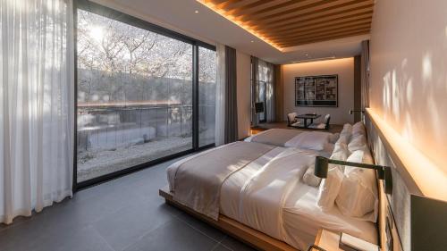 a bedroom with a bed and a large window at Mungyeong Sadamjae Stay in Mungyeong