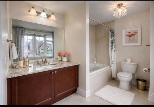 a bathroom with a sink and a toilet and a tub at Quite Cozy Private Room In Vaughan with Private Bathroom and Free Parking in Vaughan