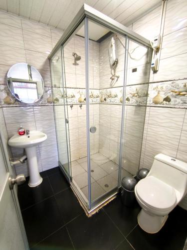 a bathroom with a shower and a toilet and a sink at Cusco Center Apartment in Cusco
