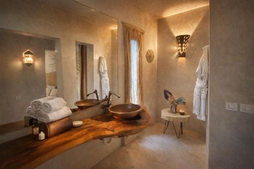 a bathroom with a wooden sink and a mirror at Jnan Lotf Marrakech - Le Jardin de la Bienveillance in Marrakesh