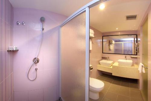 a bathroom with a shower and a toilet and a sink at Hotel Richbaliz Selayang in Batu Caves
